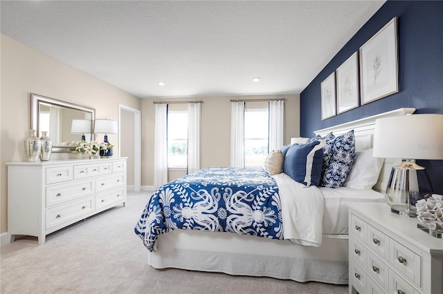 carpeted bedroom featuring a textured ceiling