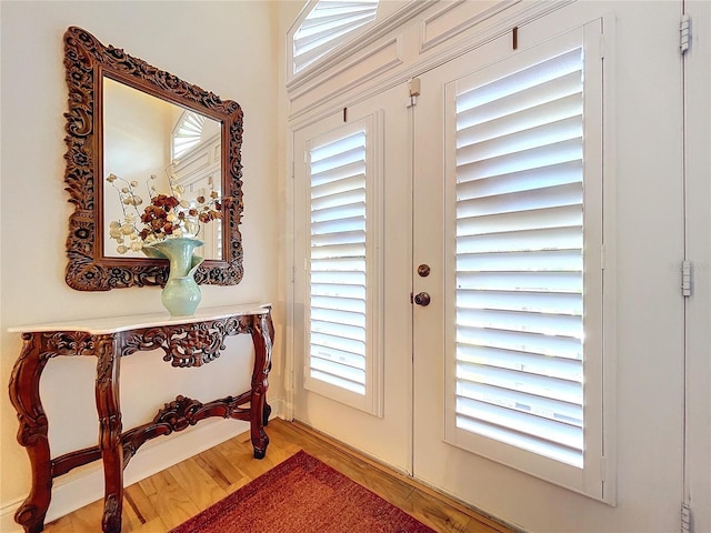 foyer entrance featuring french doors and hardwood / wood-style floors