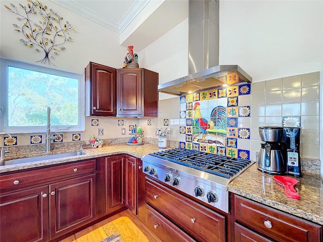 kitchen featuring sink, crown molding, light stone counters, stainless steel gas cooktop, and exhaust hood