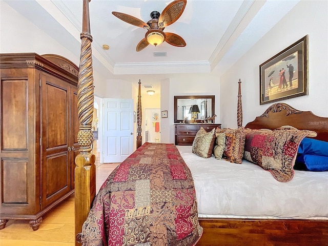 bedroom with light hardwood / wood-style flooring, ornamental molding, a raised ceiling, and ceiling fan