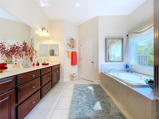 bathroom with vanity, tile patterned floors, and tiled bath