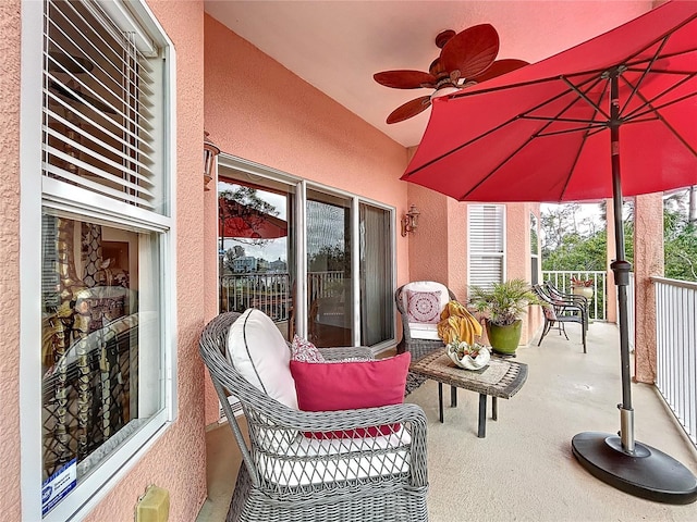 view of patio featuring ceiling fan and a balcony