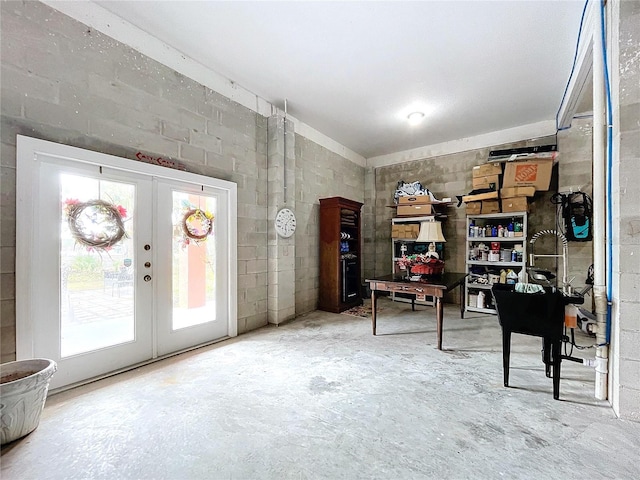 miscellaneous room featuring concrete flooring and french doors