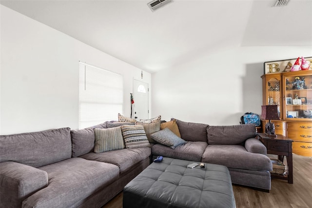 living room with dark hardwood / wood-style flooring and vaulted ceiling