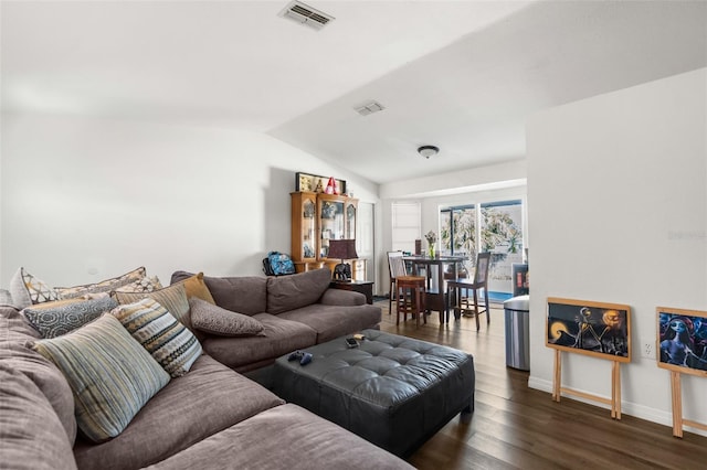 living room featuring lofted ceiling and dark hardwood / wood-style floors