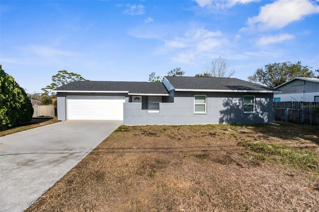 ranch-style house with a garage and a front lawn