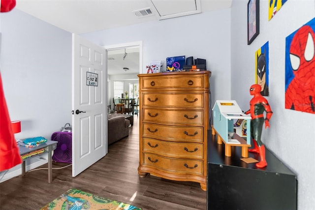 bedroom with dark hardwood / wood-style floors