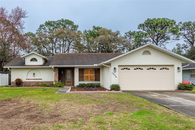 single story home with a garage and a front yard