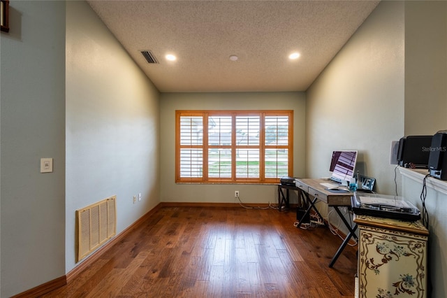 office with dark wood-type flooring and a textured ceiling