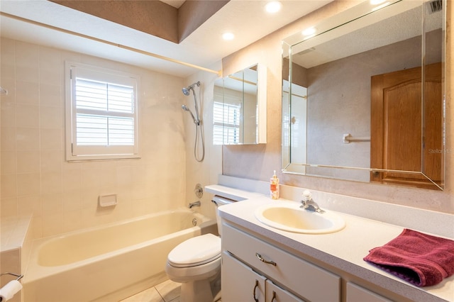 full bathroom with tile patterned floors, vanity, toilet, and tiled shower / bath combo