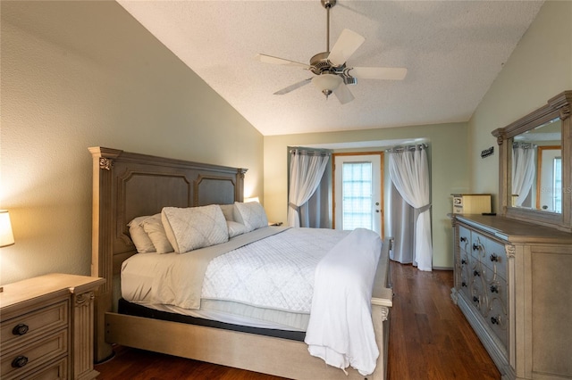 bedroom featuring ceiling fan, dark hardwood / wood-style floors, vaulted ceiling, and a textured ceiling