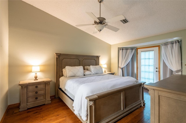 bedroom featuring dark hardwood / wood-style flooring, a textured ceiling, vaulted ceiling, and ceiling fan