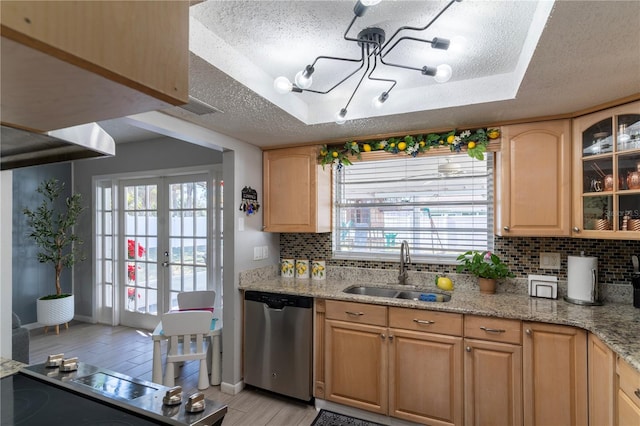 kitchen featuring dishwasher, sink, light brown cabinetry, and light stone counters