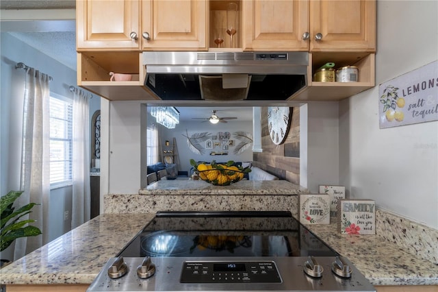 kitchen featuring stainless steel range with electric cooktop, light stone countertops, ceiling fan, and light brown cabinets