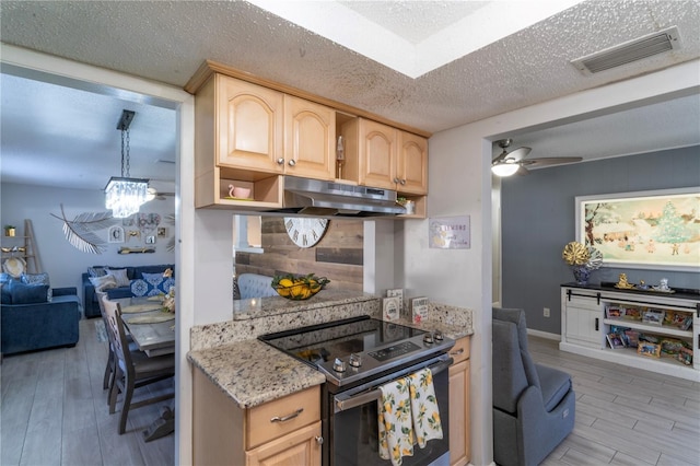 kitchen with a textured ceiling, light wood-type flooring, light brown cabinets, ceiling fan, and stainless steel electric stove