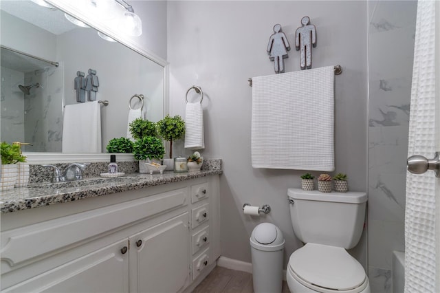 full bathroom with vanity, tiled shower / bath combo, and toilet