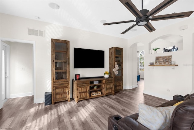 living room featuring hardwood / wood-style flooring and ceiling fan