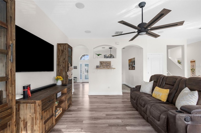 living room with wood-type flooring and ceiling fan