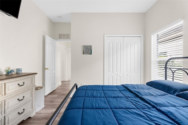 bedroom featuring hardwood / wood-style flooring and a closet