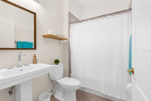 bathroom with tile patterned flooring, toilet, and walk in shower