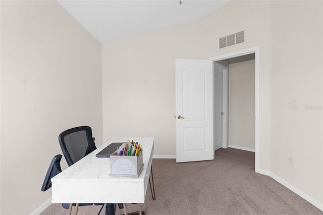 carpeted office space featuring vaulted ceiling