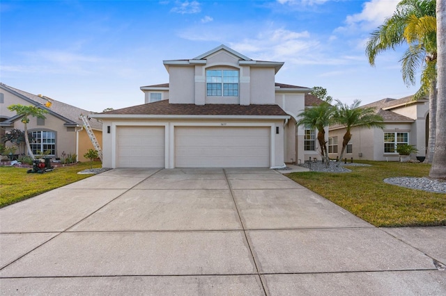 view of front facade featuring a garage and a front lawn