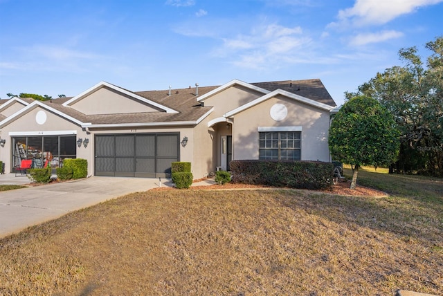 ranch-style home featuring a garage and a front yard