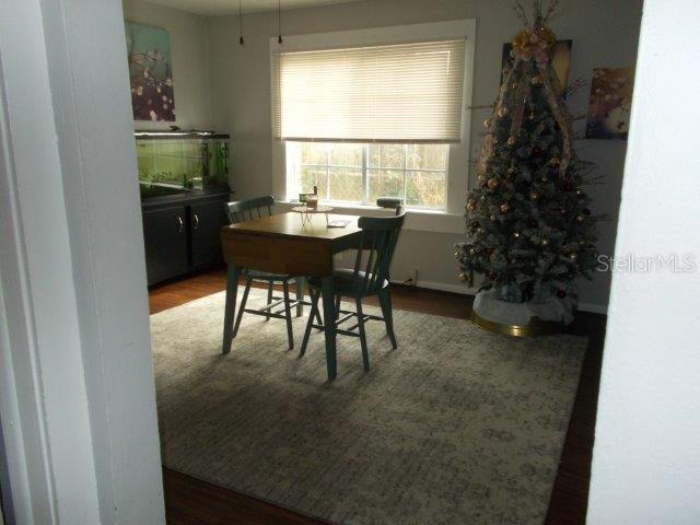 dining space with hardwood / wood-style floors