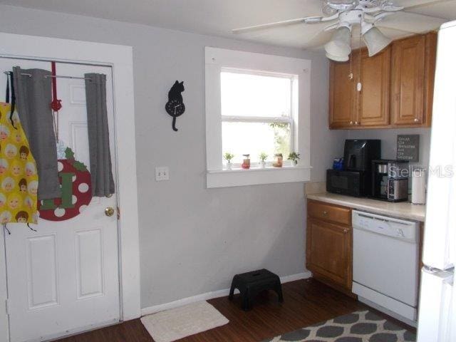 kitchen featuring ceiling fan, white appliances, and dark hardwood / wood-style floors