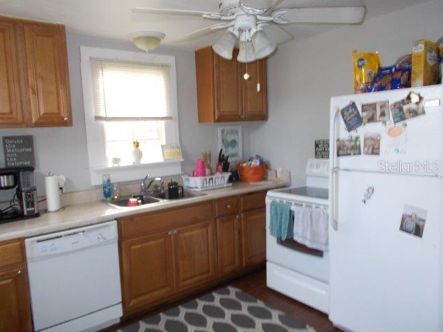 kitchen featuring sink, white appliances, and ceiling fan