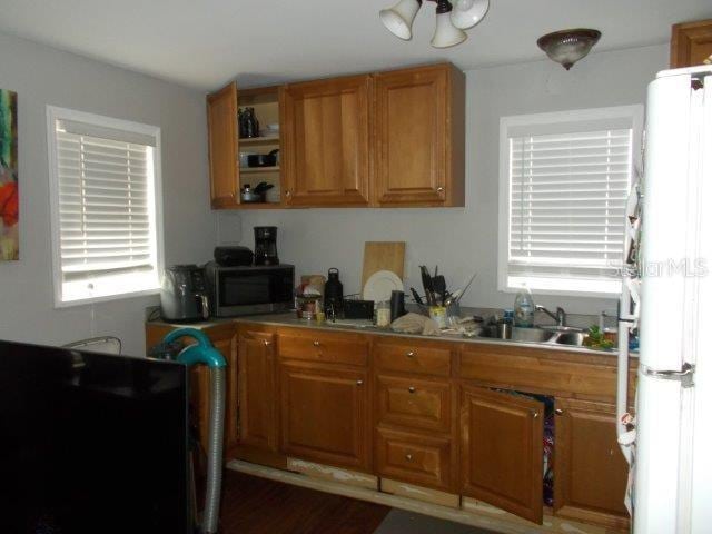 kitchen featuring white refrigerator and sink