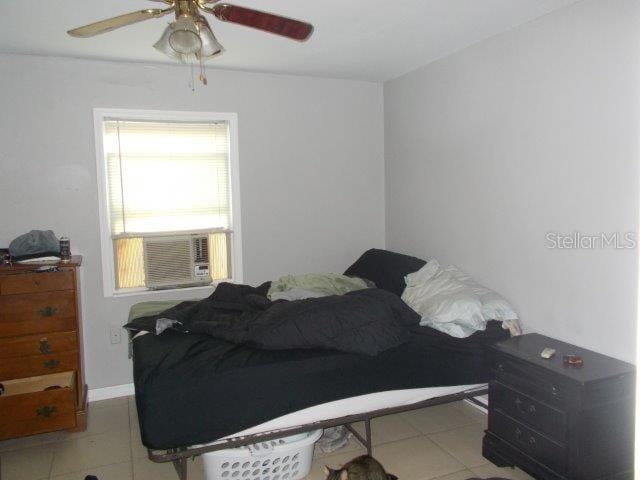 bedroom with cooling unit and ceiling fan