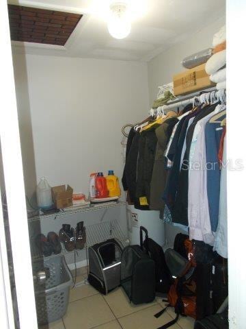 walk in closet with light tile patterned floors