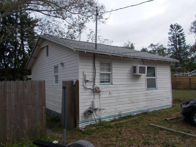 view of home's exterior with a wall unit AC