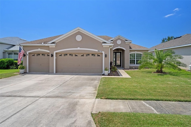 ranch-style house featuring a garage and a front lawn