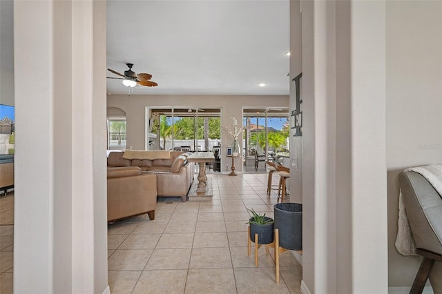 living room featuring light tile patterned floors and ceiling fan