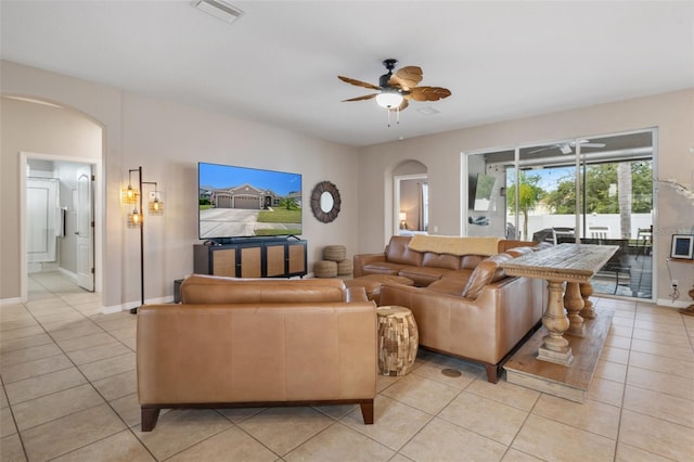 tiled living room with ceiling fan