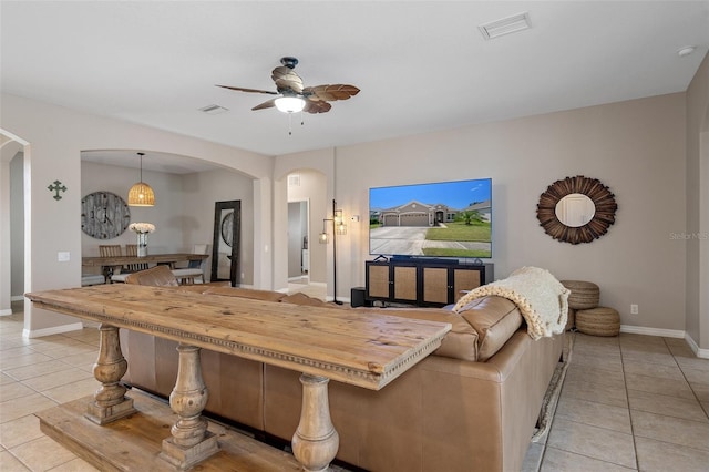 dining area with light tile patterned floors and ceiling fan