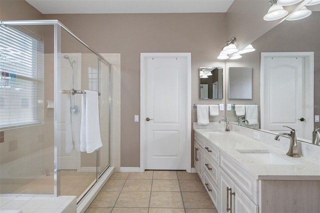 bathroom featuring vanity, tile patterned floors, and a shower with shower door