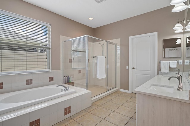 bathroom featuring tile patterned flooring, shower with separate bathtub, and vanity