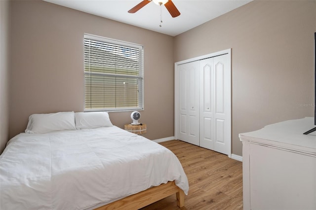 bedroom with ceiling fan, a closet, and light hardwood / wood-style flooring