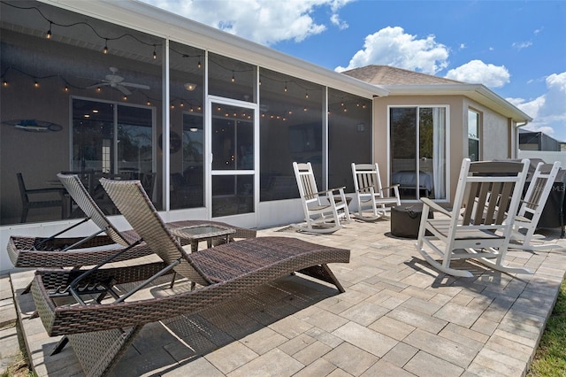 view of patio with a sunroom and ceiling fan