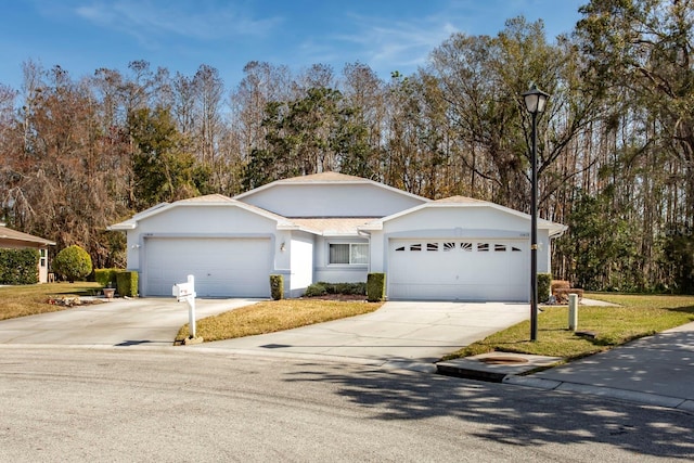 view of front of house featuring a garage and a front lawn