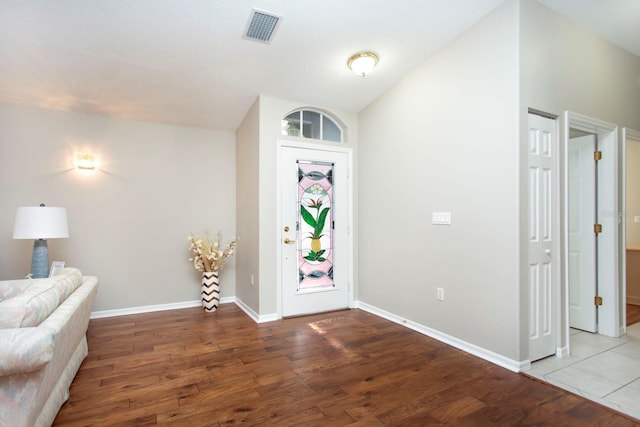 foyer with lofted ceiling and light wood-type flooring