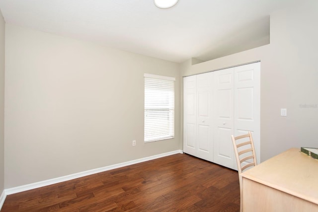 unfurnished office with dark wood-type flooring