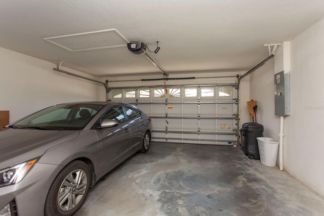 garage featuring a garage door opener and electric panel