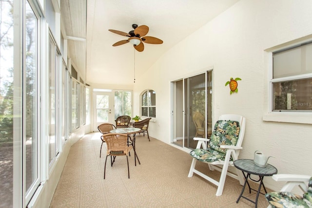 sunroom with ceiling fan and vaulted ceiling