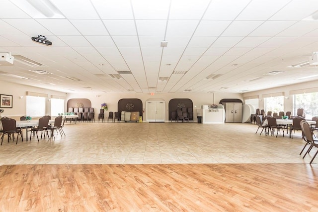 misc room with light hardwood / wood-style flooring and a paneled ceiling