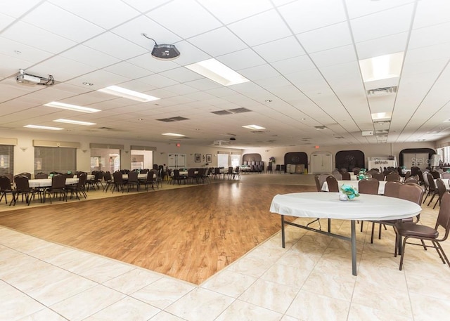 interior space featuring a drop ceiling and hardwood / wood-style flooring