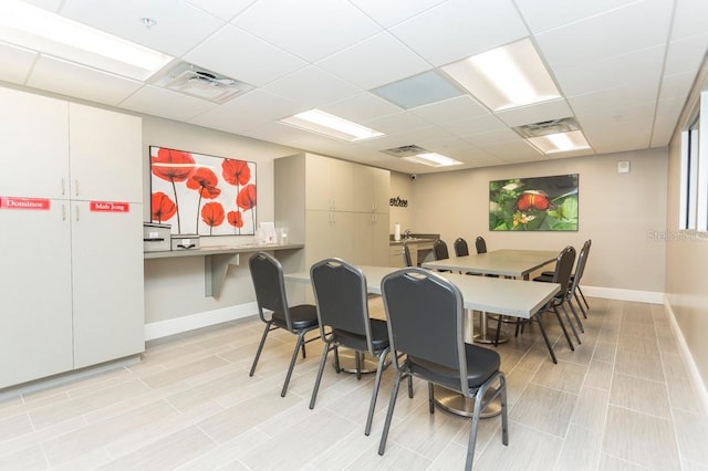 dining area featuring a paneled ceiling